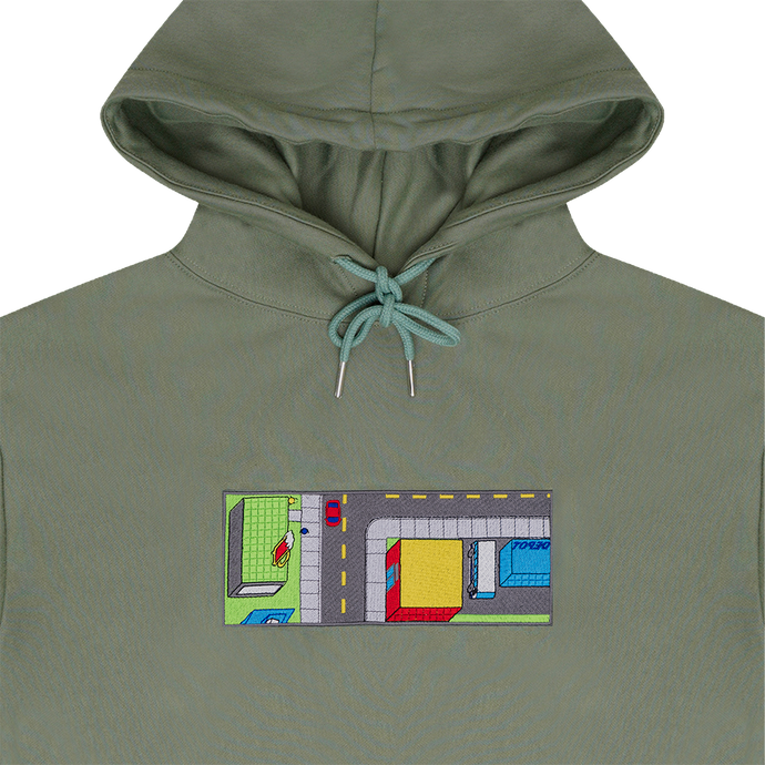 Collar shot photograph of green hoodie with embroidery design