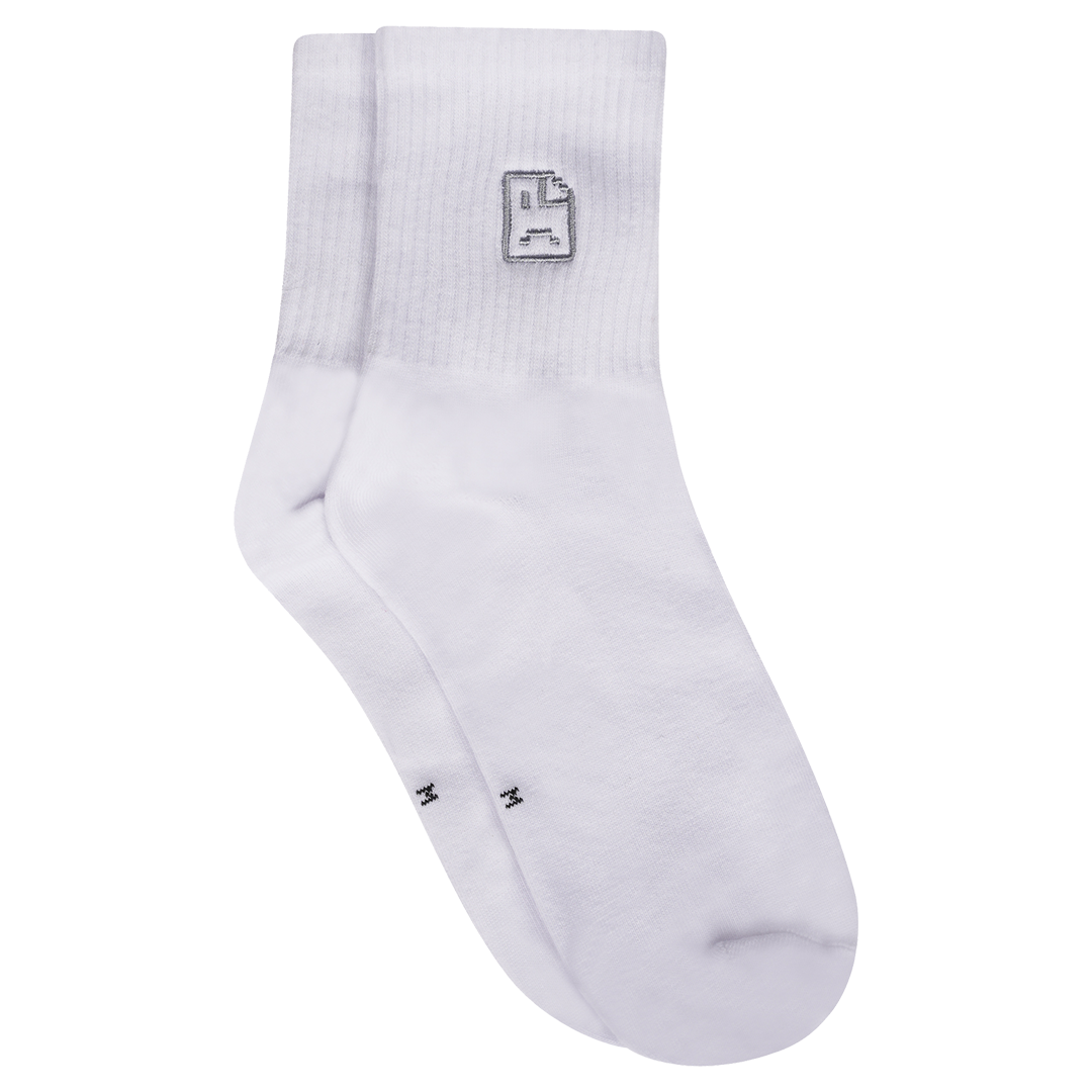 Photograph of white socks with sad face embroidery design