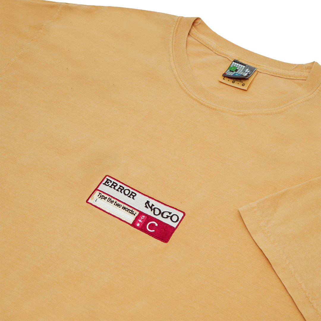 Side-angle photograph of yellow tshirt with captcha embroidery design