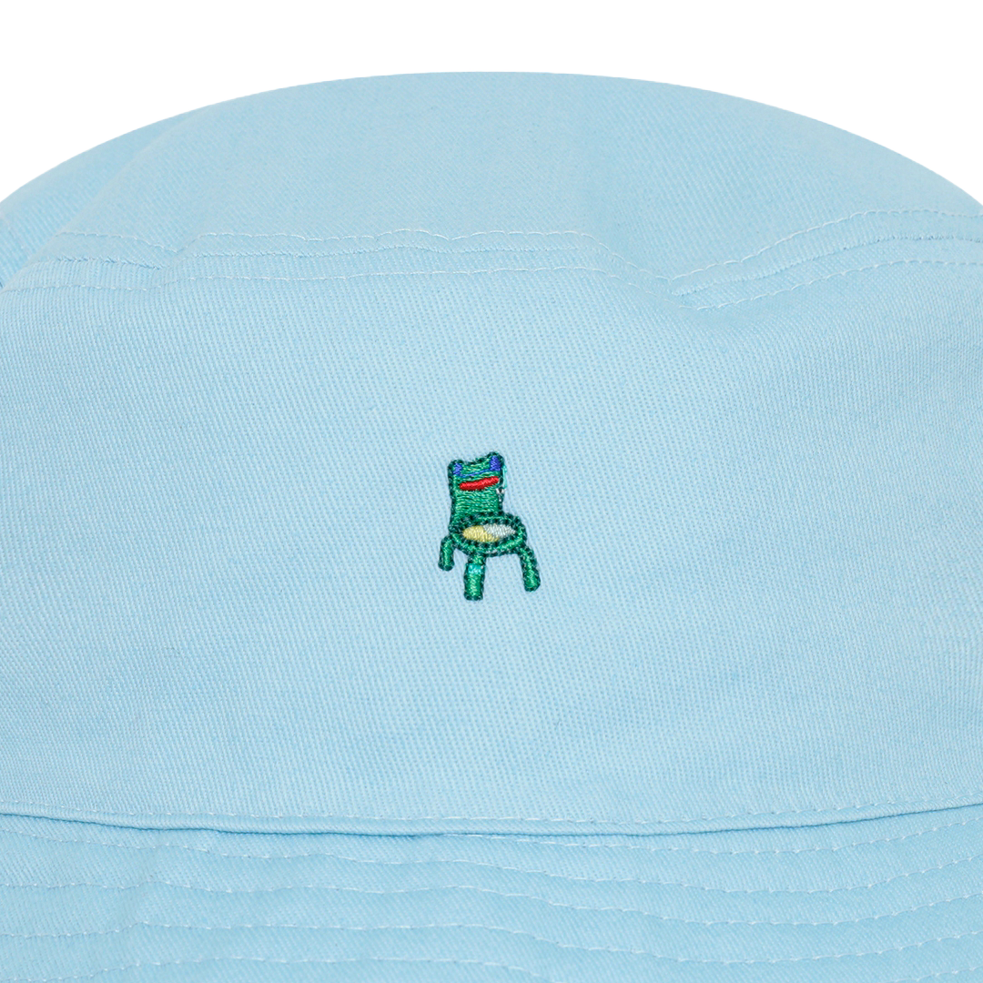 Photograph of a blue bucket hat with an embroidered froggy chair design