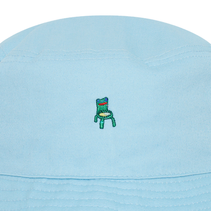 Photograph of a blue bucket hat with an embroidered froggy chair design
