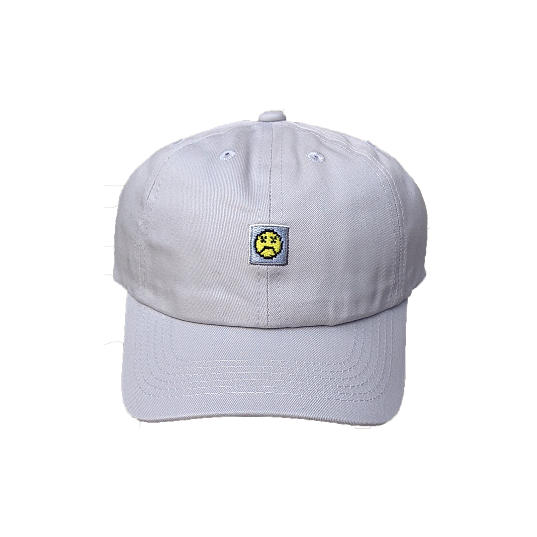 Photograph of grey minesweeper cap with embroidered sad face design
