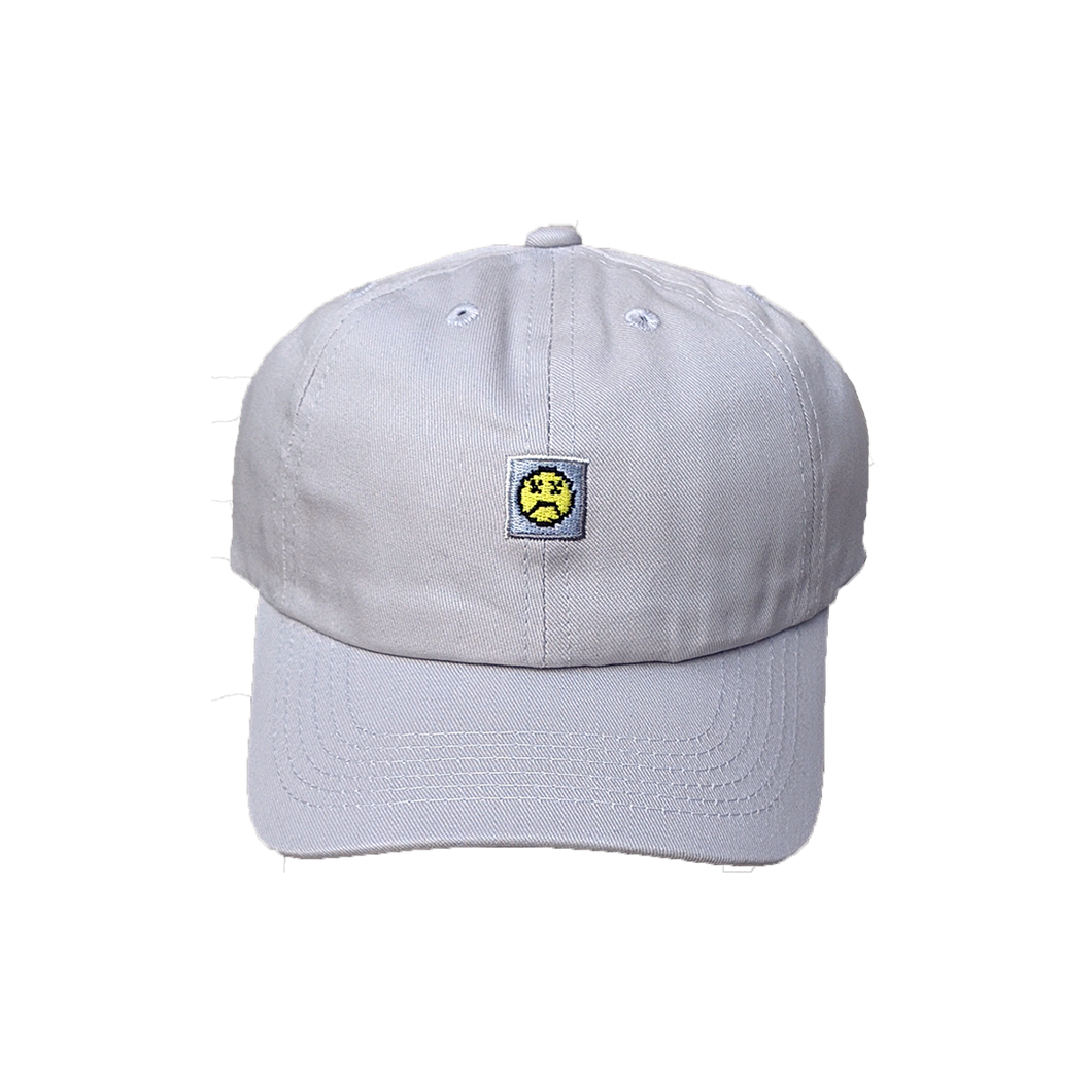 Photograph of grey minesweeper cap with embroidered sad face design