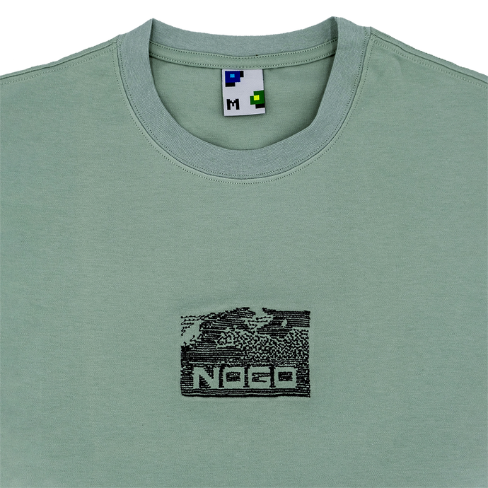 Collar shot photograph of green tshirt with embroidery design that reads nogo