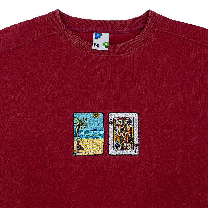 Collar shot photograph of red crewneck with solitaire card embroidery