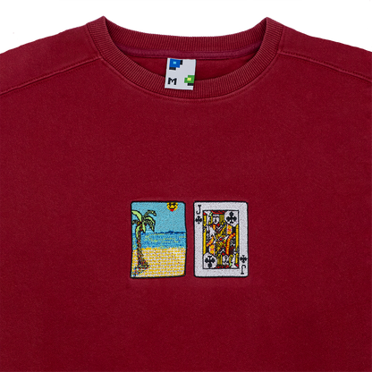 Collar shot photograph of red crewneck with solitaire card embroidery