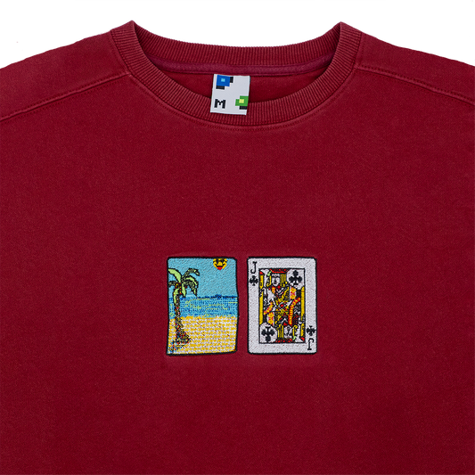 Collar shot photograph of red crewneck with solitaire card embroidery