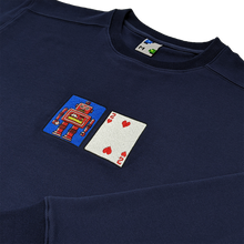 Load image into Gallery viewer, Side-angle photograph of navy blue crewneck with solitaire playing card embroidery
