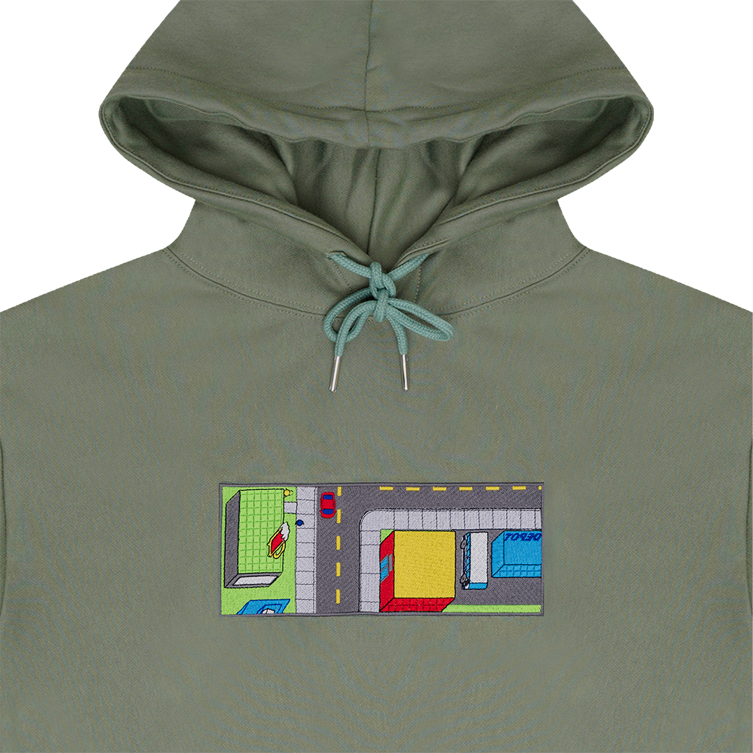 Collar shot photograph of green hoodie with embroidery design