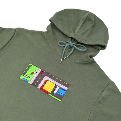 Side-angle photograph of green hoodie with embroidery design